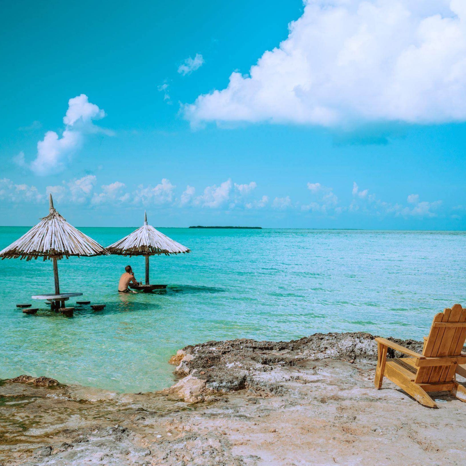 Beautiful Belize beach scene showcasing what to pack for Belize vacation with beach huts and turquoise water