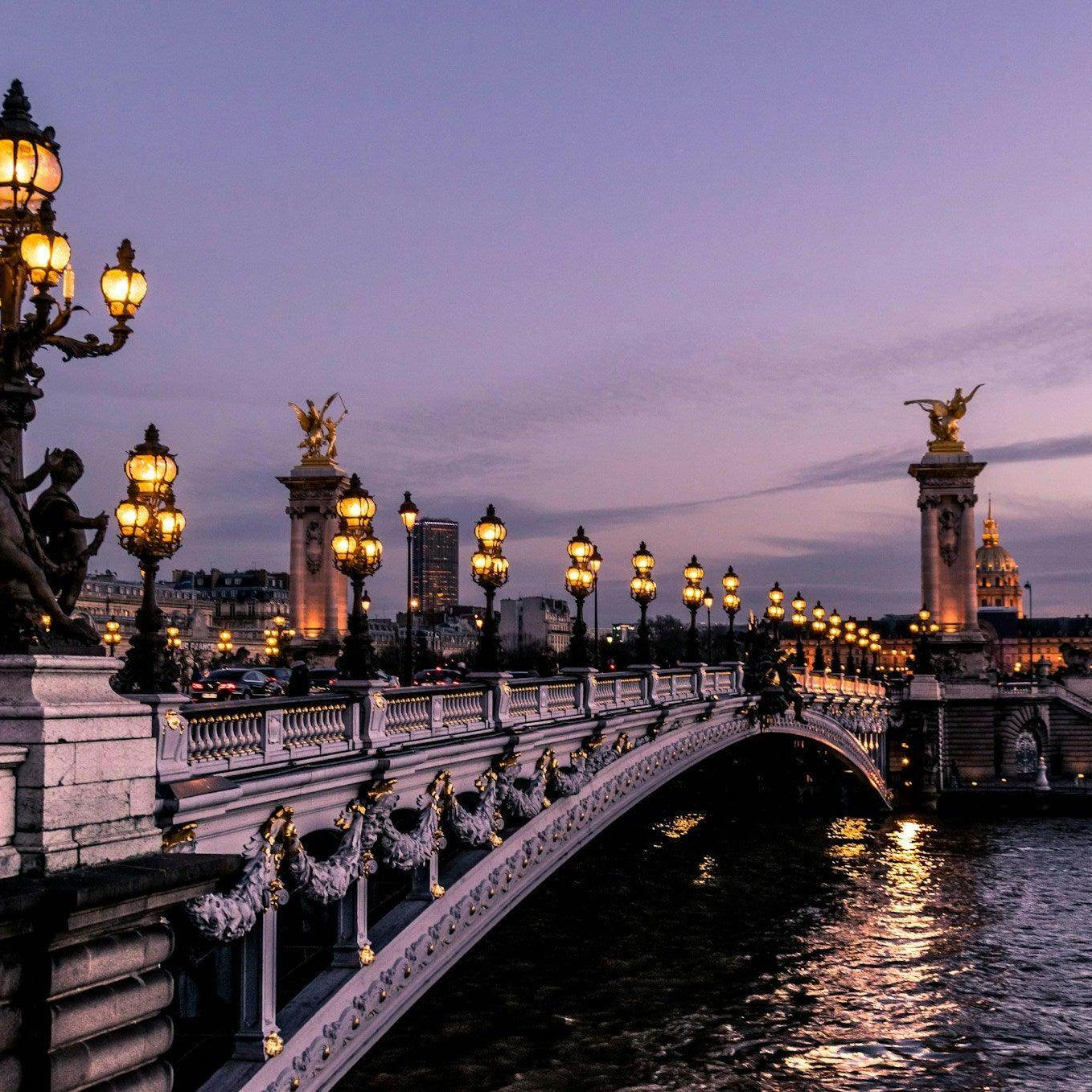 Scenic view of illuminated bridge in Paris with hints of France travel mistakes to avoid