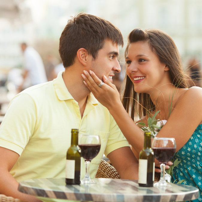 Couple enjoying a romantic dinner with wine, perfect for romantic vacation gift ideas