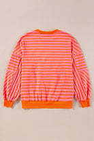 JUNIPER BLVD striped drop shoulder sweatshirt in vibrant pink and orange stripes with a relaxed fit