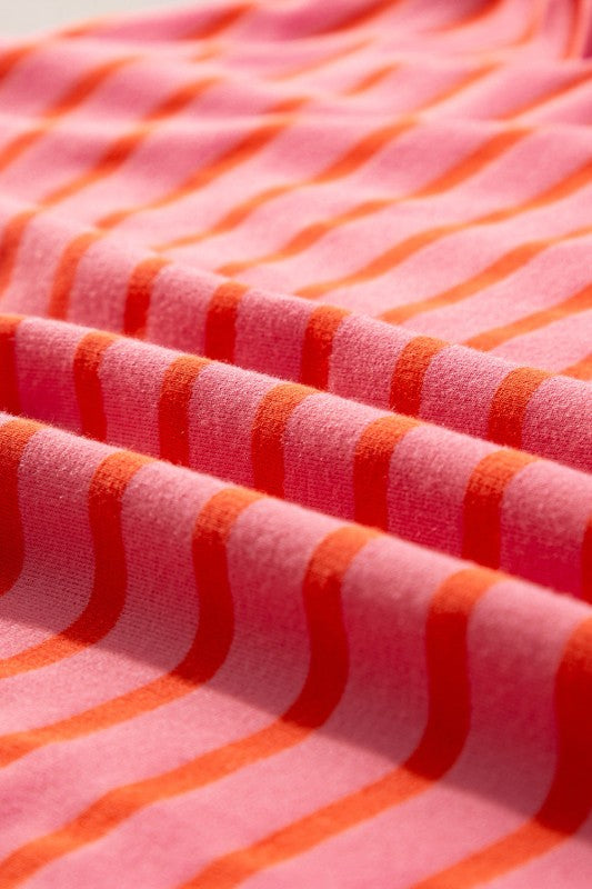 Close-up of JUNIPER BLVD striped drop shoulder sweatshirt in pink and orange fabric folds