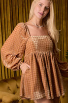 Stylish velvet square neck romper in warm tones with puff sleeves and pockets, perfect for vacations