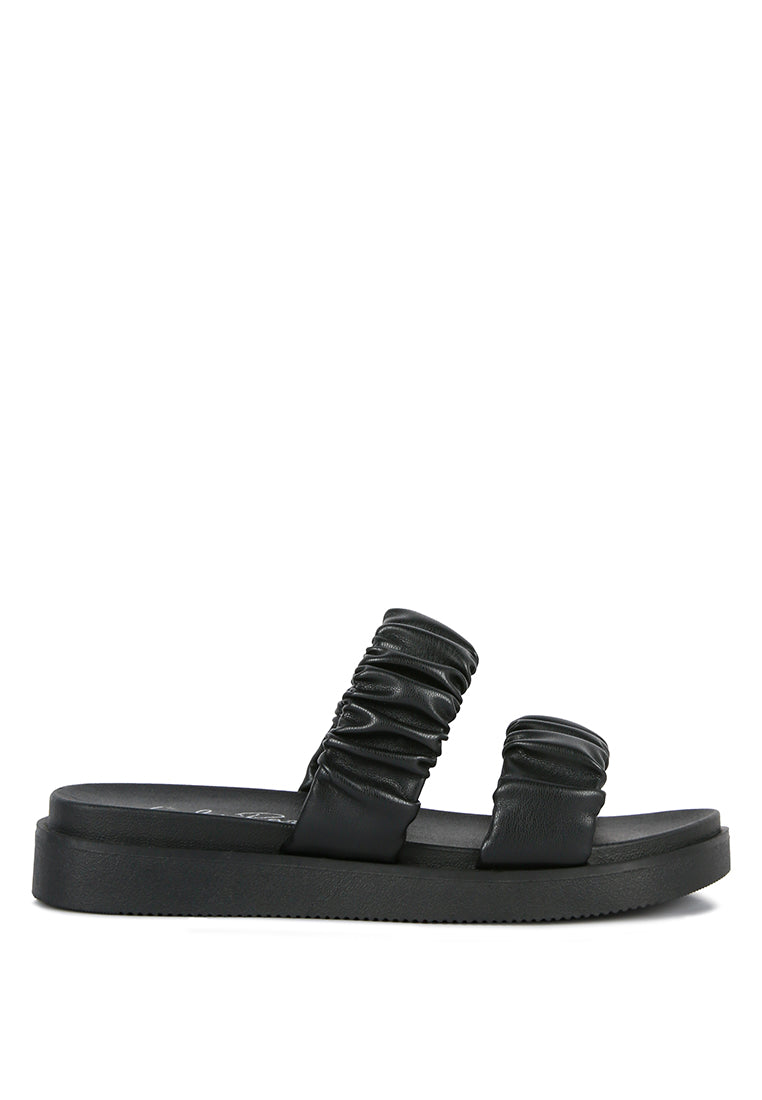 Black sandal with ruched straps on a white background