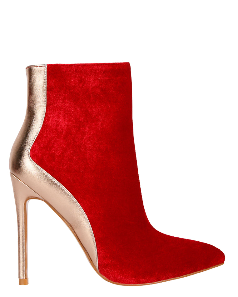 Red ankle boot with gold metallic heel on a light gray background