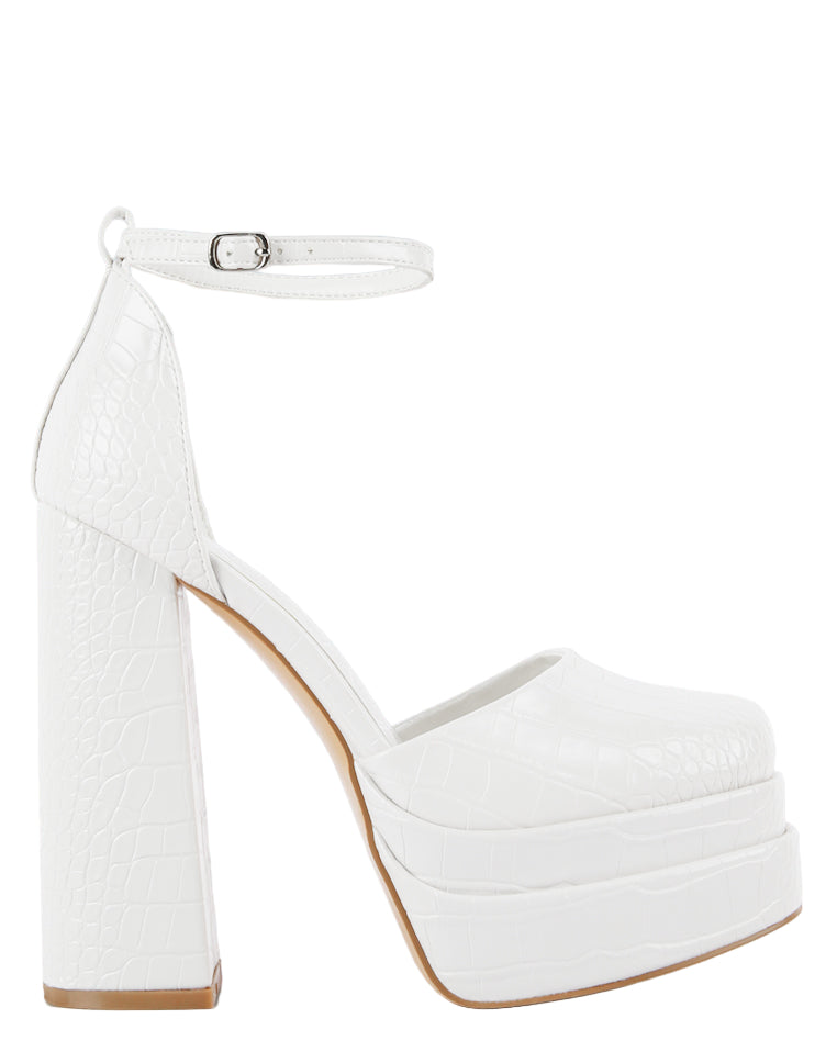 White platform high-heeled shoes on a light gray background