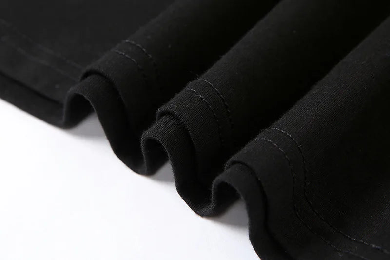 Close-up detail of black fabric stitching on an aesthetic streetwear summer top for casual style