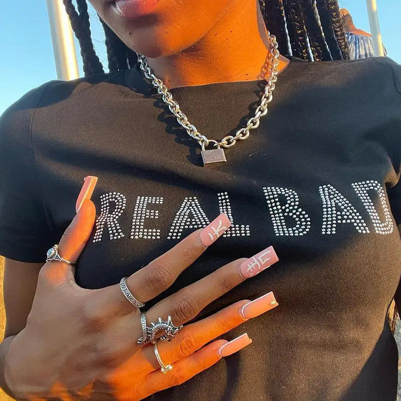Aesthetic streetwear summer top in black with rhinestone Real Bad lettering and chunky silver chain necklace