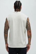 VacationGrabs men's white summer streetwear sleeveless shirt shown from the back with tattooed arms