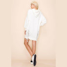 Back view of Amour sweatshirt dress in white with lace-up sides and hood for a stylish and comfortable look