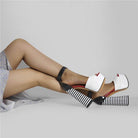 Stylish women's ankle strap square heel sandals in black and white with bold striped design