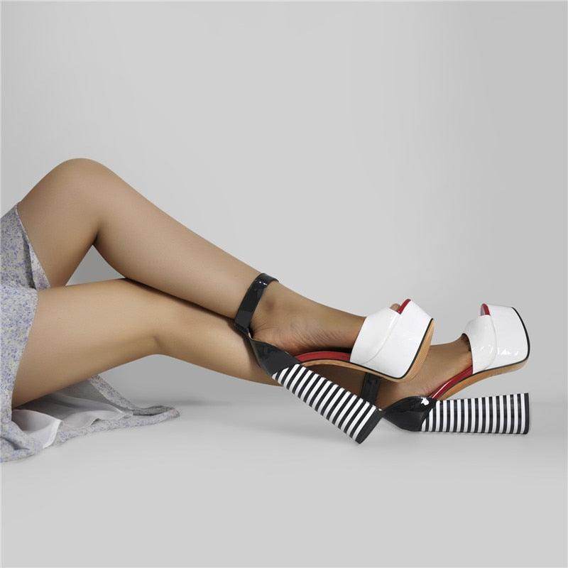 Stylish women's ankle strap square heel sandals in black and white with bold striped design