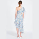 Back view of Emory Park asymmetric one shoulder dress in blue floral pattern, featuring ruffled hem