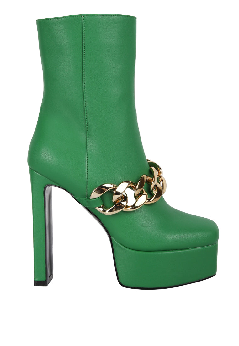 Green platform boot with gold chain detail on a white background