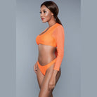 Model wearing BE WICKED 1980s inspired crop swim set in bright orange long sleeve top and high cut bottoms