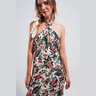 Stylish women's beige paisley maxi dress with a halter neck and floral patterns