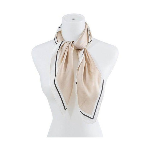 Beige silk scarf by Bella Chic elegantly styled on a mannequin with contrasting black trim