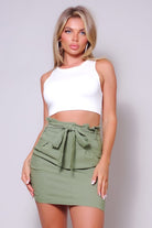 Belted green mini skirt for women styled with a white crop top by VacationGrabs