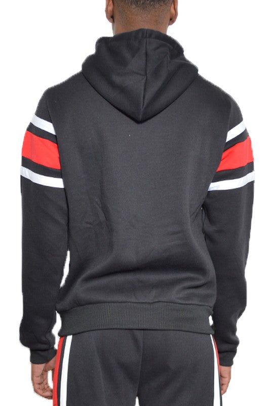 Back view of black and red striped hoodie with white accents worn by male model