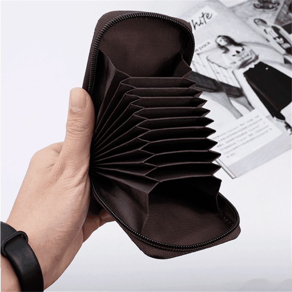 Hand holding a spacious black brown leather wallet with multiple compartments for organization