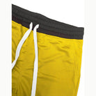 Men's yellow shorts with black chevron trim shorts and adjustable drawstring waistband