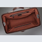Inside view of black coffee leather duffel featuring spacious brown interior and multiple pockets