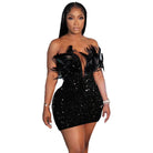 Woman wearing a black sequin feather mini dress with off-shoulder design and deep neckline