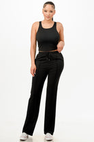 VacationGrabs womens matching tank and pants set in black worn by model with casual white sneakers