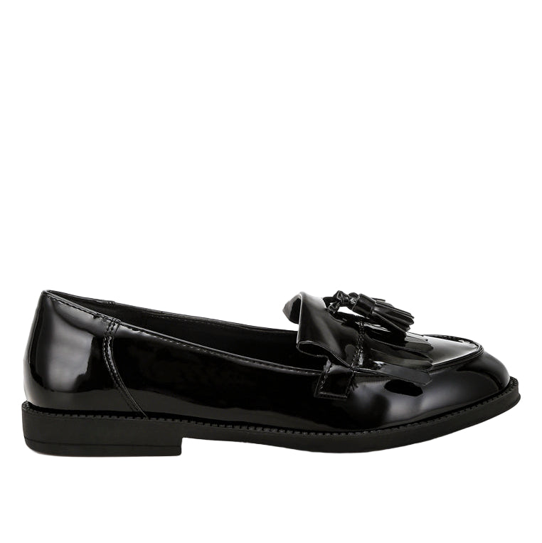 Black patent leather loafer with tassel on a white background
