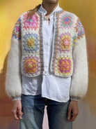 Colorful women's sweater in boho vacation style clothing featuring floral patterns and cozy texture