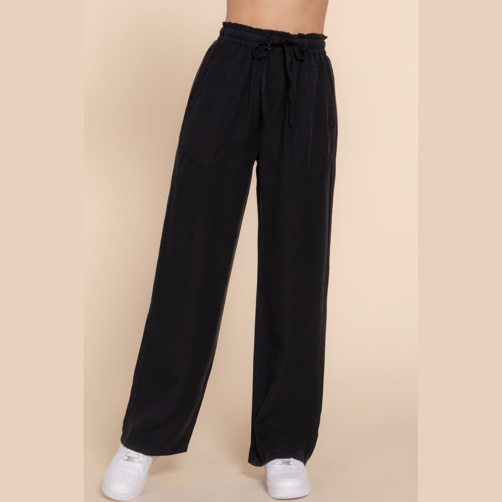 Black lightweight travel pants for women with elastic waistband and drawstring by VacationGrabs