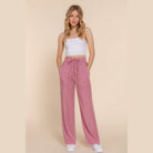Lightweight travel pants for women in pink with drawstring waist and pockets from VacationGrabs