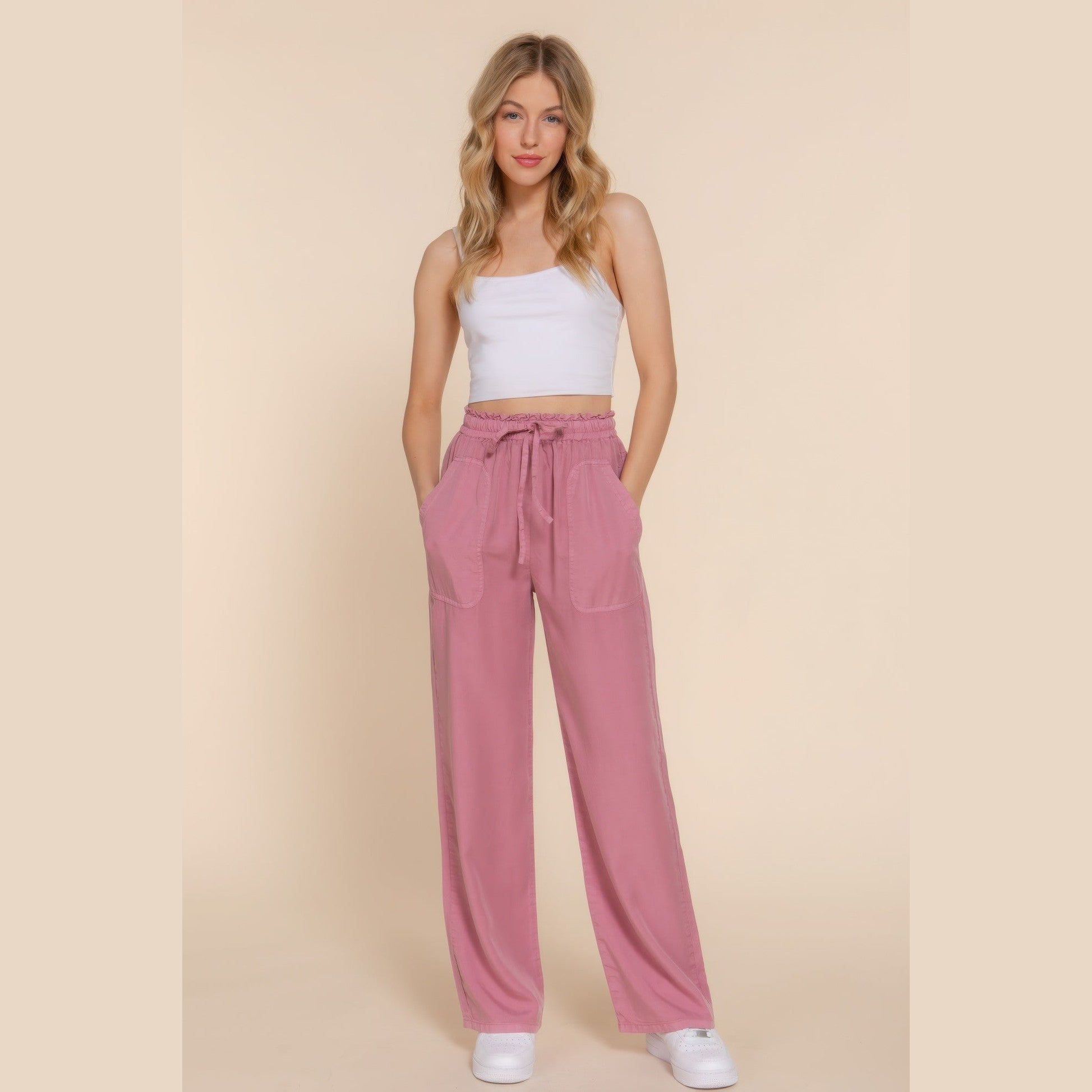 Lightweight travel pants for women in pink with drawstring waist and pockets from VacationGrabs