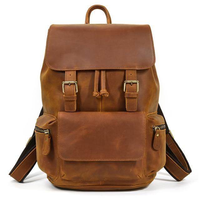 Brown leather laptop backpack with adjustable straps and multiple pockets for storage