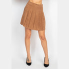 VacationGrabs casual A-line corduroy skirt in brown pleated design worn with black heels
