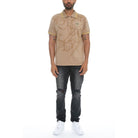 WEIV casual embroidered polo shirt in beige with intricate designs worn with black ripped jeans and white sneakers