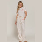 Women wearing casual vacation lounge pants and matching t-shirt in light beige by VacationGrabs