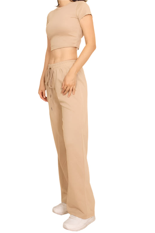 Woman wearing beige casual wide-leg pants outfit with drawstring waist and cropped top