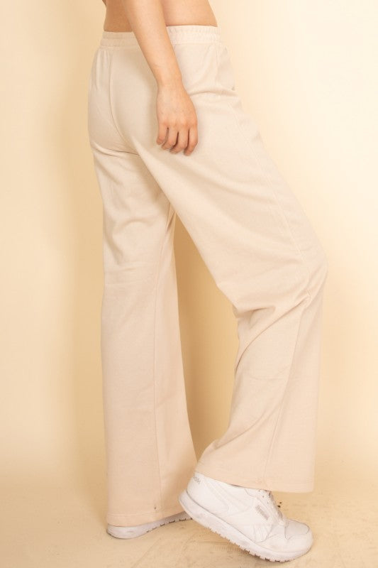Capella beige casual wide-leg pants outfit with elastic waistband and white sneakers