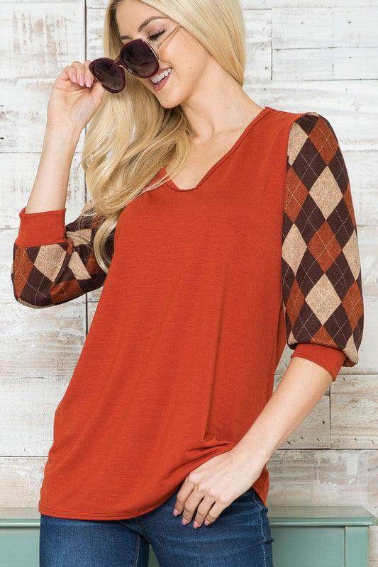 Checker pattern women's top with orange body and stylish plaid sleeves for a trendy look
