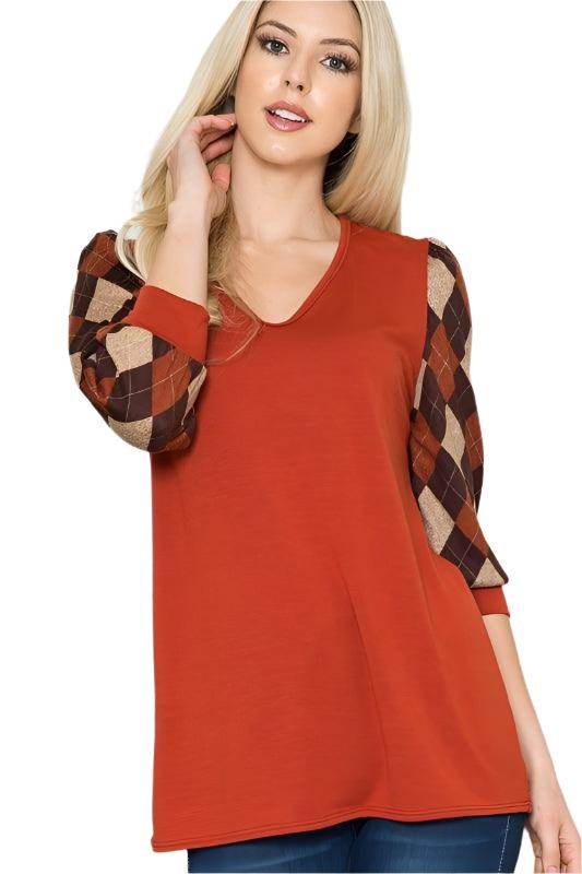 Checker pattern women's top with brown and orange sleeves and a solid body for a stylish look