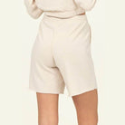 Back view of HYFVE women's chill babe shorts in beige with a relaxed fit and frayed hem
