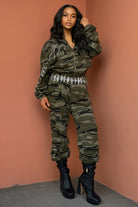 Model wearing New York inspired camouflage outfit two piece zip hoodie and joggers with embellished waist and black heeled boots
