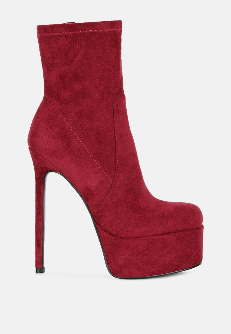 Red high-heeled platform boot on a white background