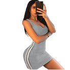 Woman wearing a fitted grey clubwear short dress for women with white side stripes taking a mirror selfie