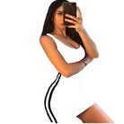 Woman wearing a white clubwear short dress for women with black side stripes taking a mirror selfie