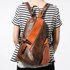 Stylish color block daypack in brown and orange with zippered pockets for everyday use