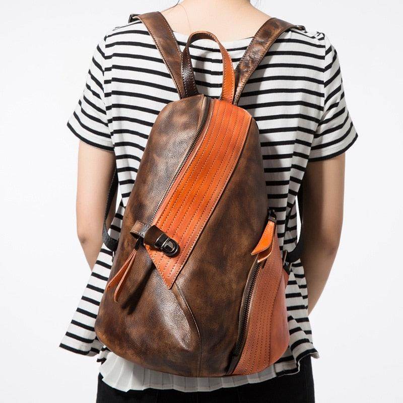 Stylish color block daypack in brown and orange with zippered pockets for everyday use