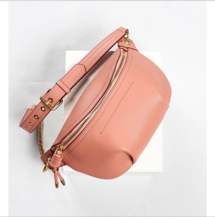 Stylish pink leather fanny pack from VacationGrabs featuring a gold zipper and adjustable strap