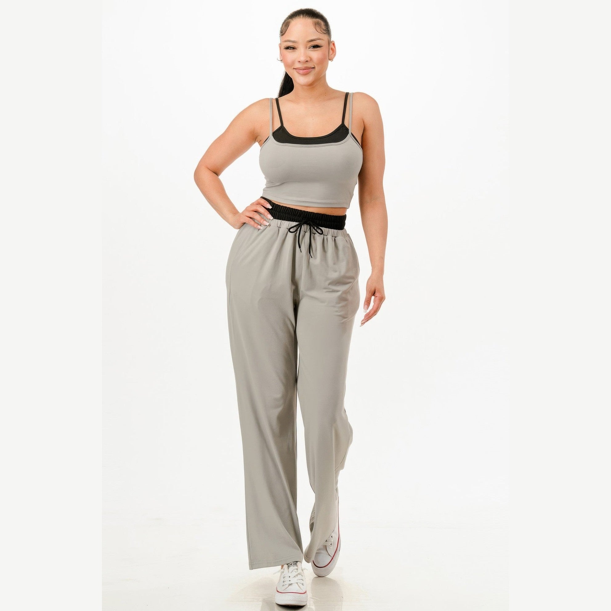 Woman wearing comfortable matching loungewear set with gray pants and fitted tank top from VacationGrabs