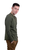 Generation XYZ comfortable travel Henley shirt in olive green worn by man with brown pants